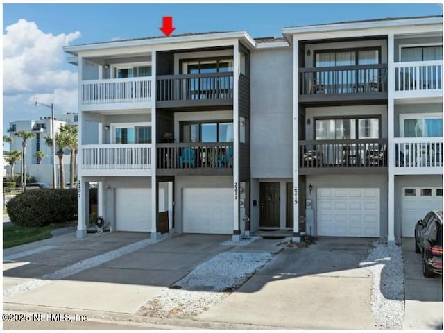 2211 1st St S, Jacksonville Beach, FL 32250 - view of front of property featuring a garage, driveway, and stucco siding