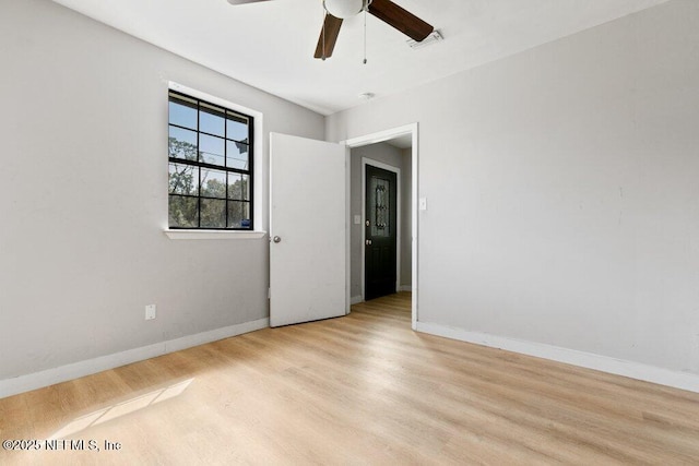 3135 Soutel Dr, Jacksonville, FL 32208 - empty room with light wood finished floors, baseboards, visible vents, and ceiling fan