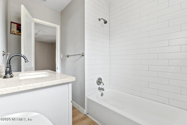 3135 Soutel Dr, Jacksonville, FL 32208 - full bath with shower / bathtub combination, a textured ceiling, wood finished floors, and vanity