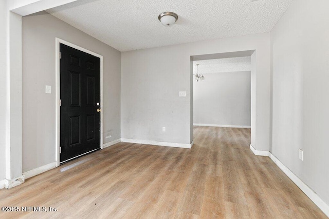 3135 Soutel Dr, Jacksonville, FL 32208 - entryway featuring a textured ceiling, baseboards, and wood finished floors