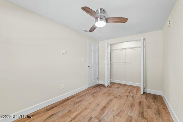 unfurnished bedroom with a closet, visible vents, light wood-style flooring, and baseboards