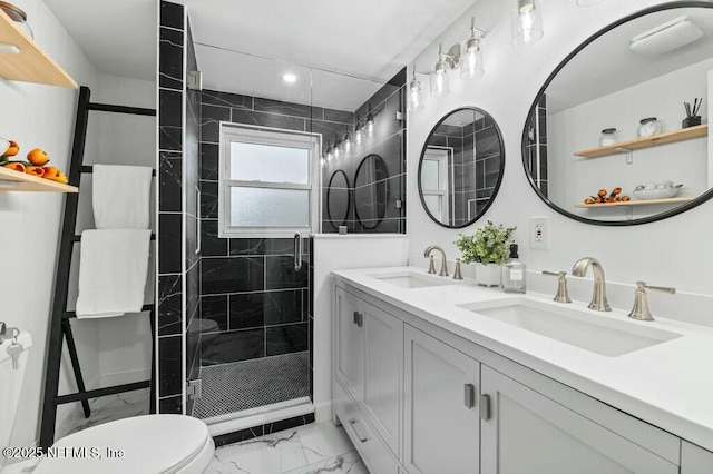 bathroom with a stall shower, marble finish floor, a sink, and toilet