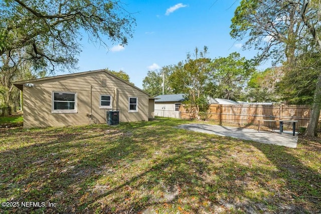 view of yard featuring fence, cooling unit, and a patio