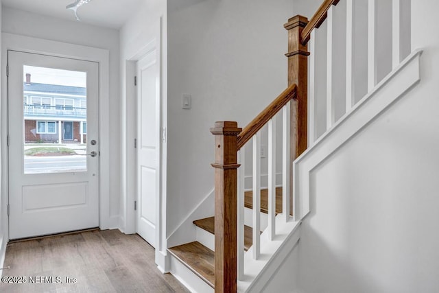 entryway featuring stairway and wood finished floors