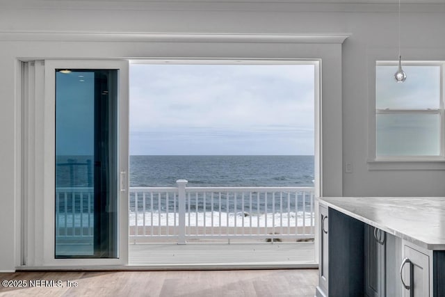 balcony with a water view and a beach view