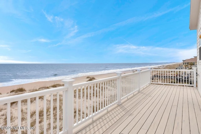 deck featuring a water view and a view of the beach