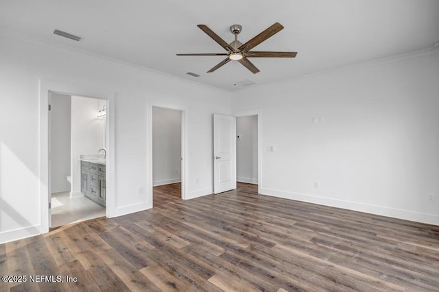 unfurnished bedroom featuring ornamental molding, dark wood-style flooring, visible vents, and baseboards