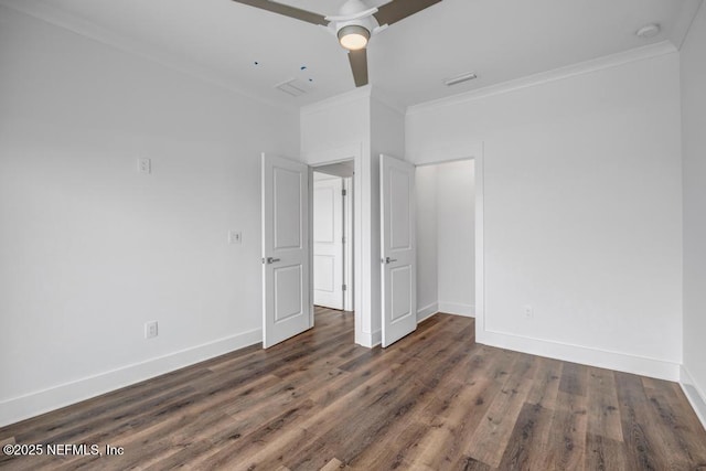 unfurnished bedroom with crown molding, visible vents, ceiling fan, wood finished floors, and baseboards