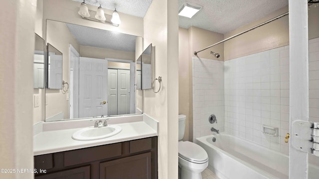 full bathroom with vanity, a textured ceiling, toilet, and shower / bathtub combination