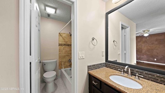 bathroom with a textured ceiling, tile patterned flooring, toilet, vanity, and tasteful backsplash