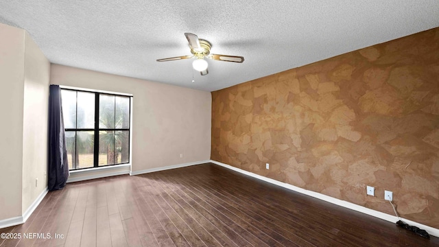 unfurnished room featuring wood-type flooring, baseboards, and a ceiling fan