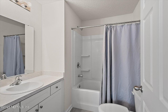 bathroom with toilet, shower / tub combo with curtain, a textured ceiling, and vanity