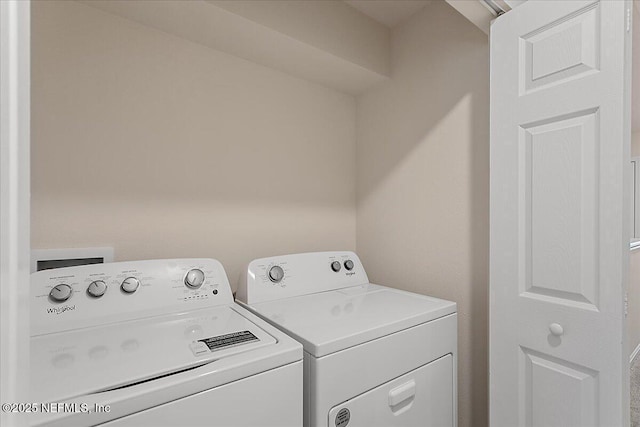 clothes washing area featuring laundry area and washing machine and clothes dryer