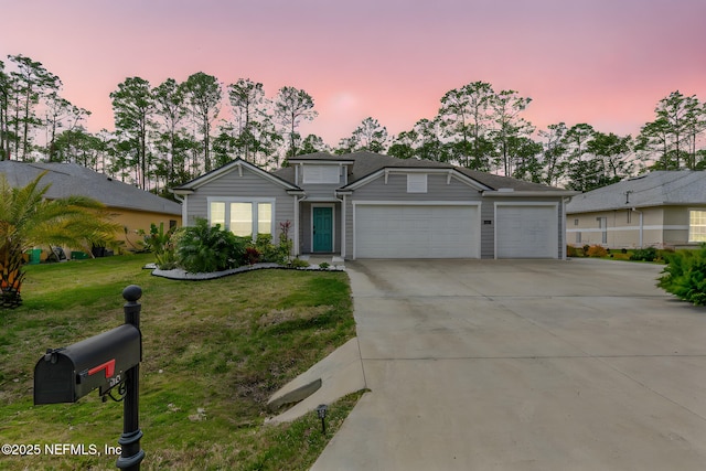 single story home featuring concrete driveway, a yard, and an attached garage