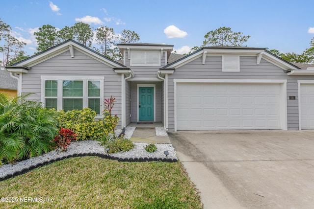 view of front of house with concrete driveway and an attached garage