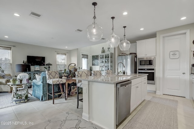 11334 Newtonian Blvd, Jacksonville, FL 32256 - kitchen featuring appliances with stainless steel finishes, a healthy amount of sunlight, a sink, and a breakfast bar area