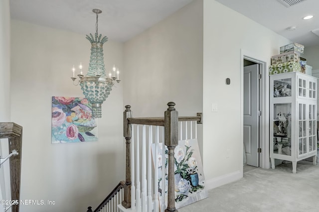 11334 Newtonian Blvd, Jacksonville, FL 32256 - hallway with carpet floors, an inviting chandelier, baseboards, and an upstairs landing