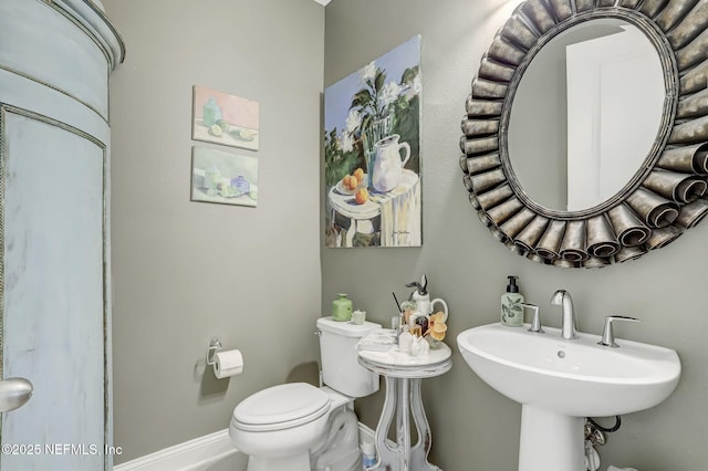 11334 Newtonian Blvd, Jacksonville, FL 32256 - half bathroom featuring a sink, toilet, and baseboards