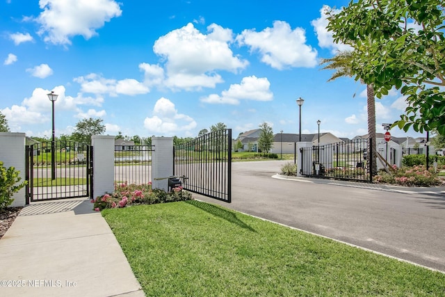 11334 Newtonian Blvd, Jacksonville, FL 32256 - view of gate with a yard, fence, and a residential view