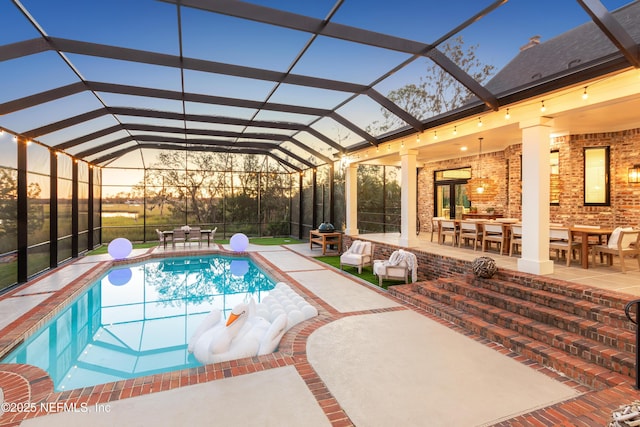 pool at dusk featuring an outdoor pool, outdoor dining space, a lanai, and a patio