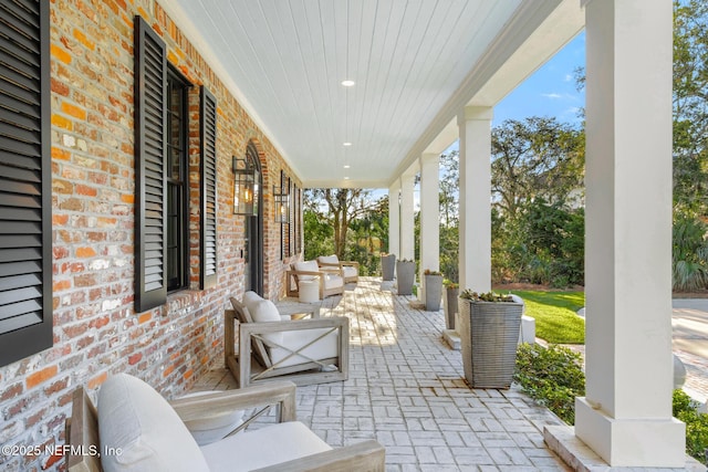 view of patio with an outdoor hangout area and a porch