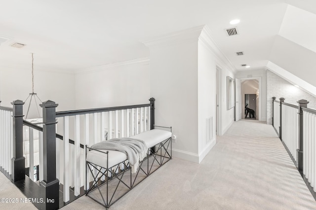 corridor featuring an upstairs landing, ornamental molding, carpet flooring, and visible vents