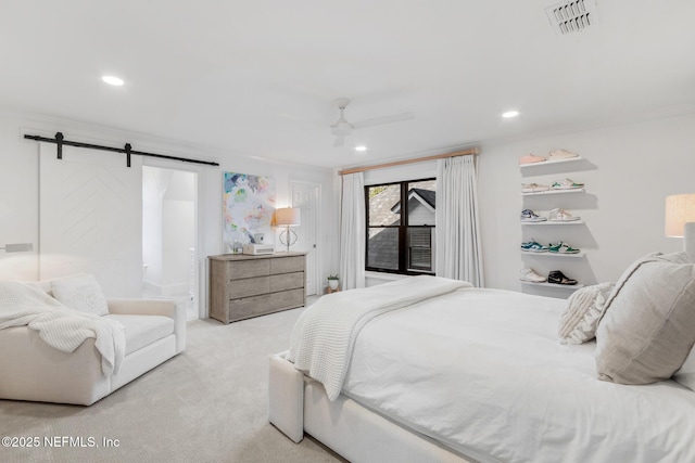 bedroom with crown molding, recessed lighting, light colored carpet, visible vents, and a barn door