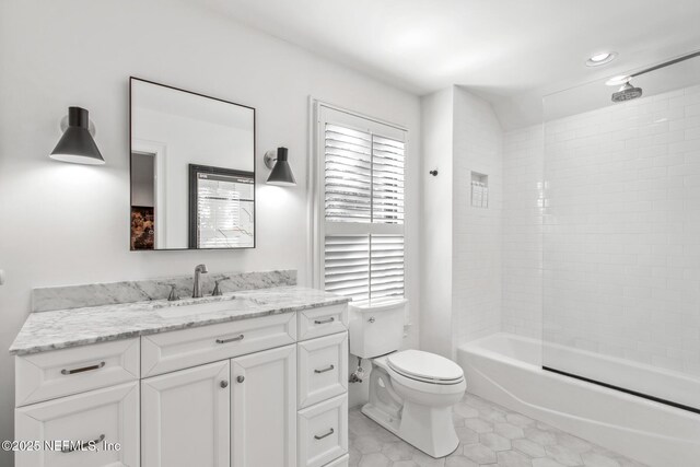 full bathroom featuring washtub / shower combination, tile patterned flooring, vanity, and toilet