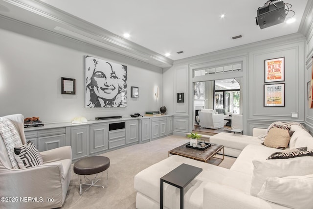 living room with ornamental molding, light colored carpet, and a decorative wall