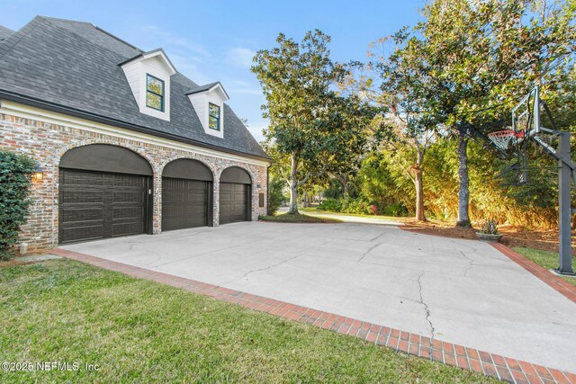 garage featuring concrete driveway