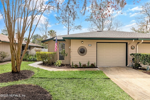 ranch-style home featuring an attached garage, fence, driveway, roof with shingles, and a front yard