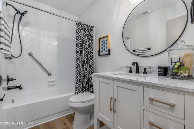 full bathroom with visible vents, shower / bathtub combination with curtain, toilet, vanity, and wood finished floors