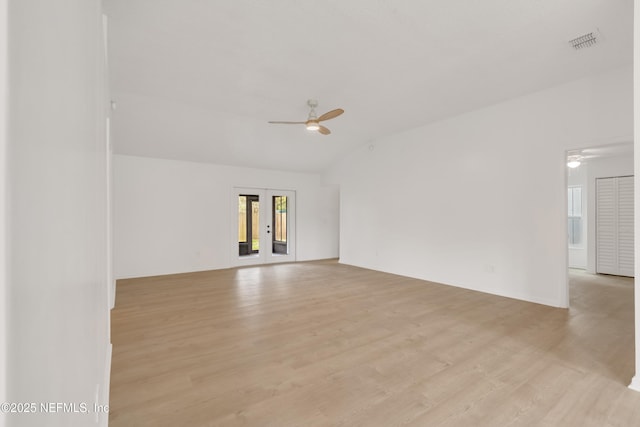 unfurnished room with french doors, visible vents, ceiling fan, and light wood-style flooring