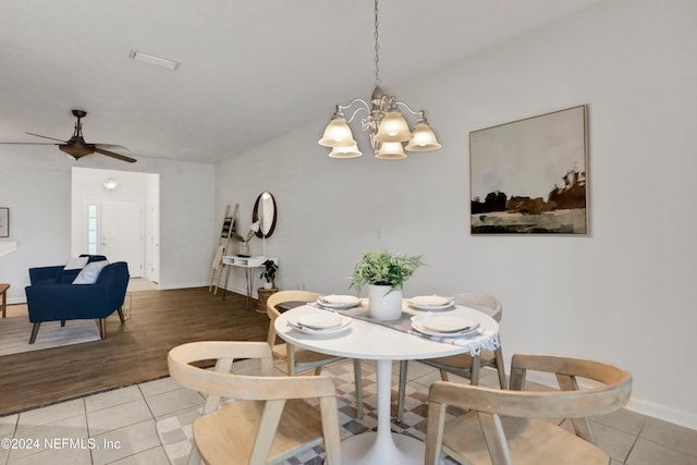 dining room featuring light tile patterned floors, baseboards, and ceiling fan with notable chandelier