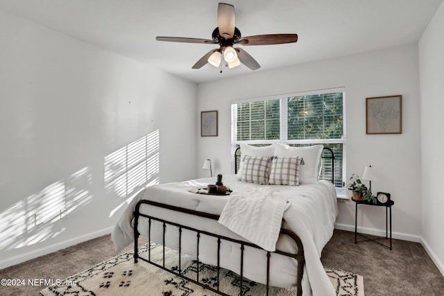 carpeted bedroom with a ceiling fan and baseboards