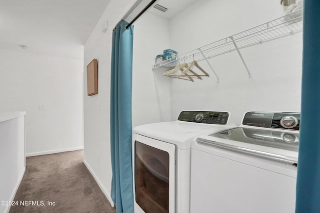 laundry area with carpet, visible vents, washing machine and dryer, laundry area, and baseboards