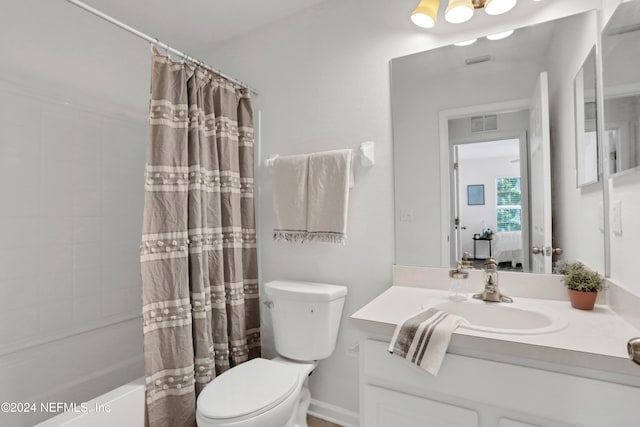 bathroom featuring shower / bath combination with curtain, visible vents, vanity, and toilet