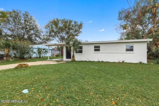 single story home with a front yard and stucco siding