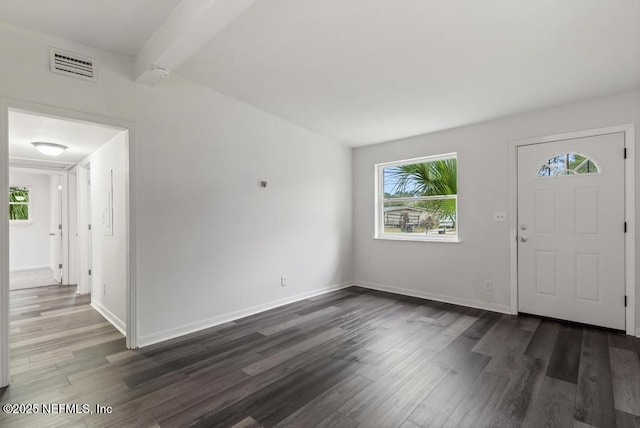 foyer entrance featuring dark wood-style floors, beam ceiling, visible vents, and baseboards