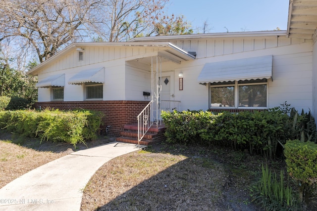 view of front of property with board and batten siding and brick siding