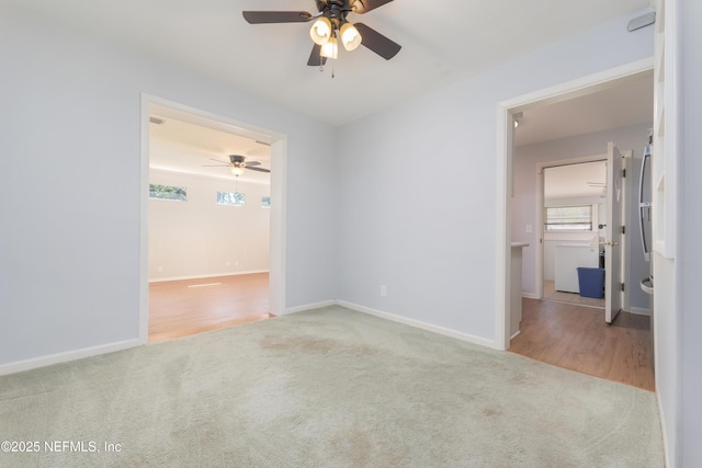 spare room with baseboards and carpet flooring