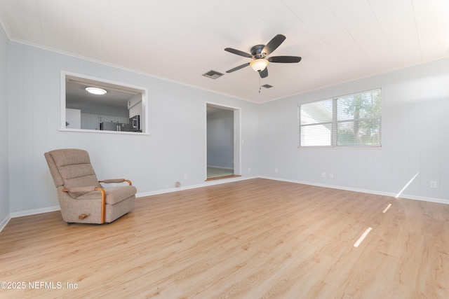 unfurnished room with a ceiling fan, baseboards, ornamental molding, and wood finished floors