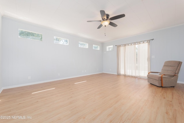 unfurnished room featuring a ceiling fan, crown molding, light wood-style flooring, and baseboards