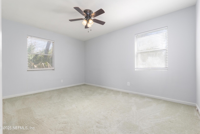 unfurnished room featuring carpet, a ceiling fan, and baseboards