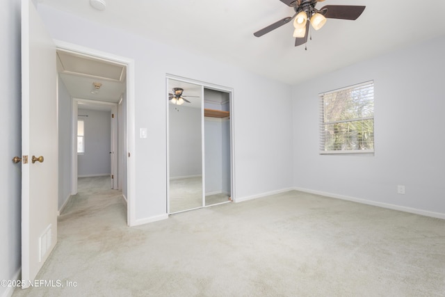 unfurnished bedroom with a closet, visible vents, carpet flooring, ceiling fan, and baseboards