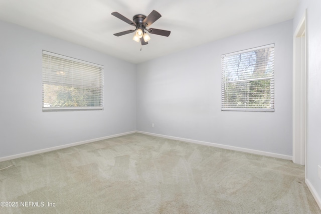 empty room featuring carpet, ceiling fan, and baseboards