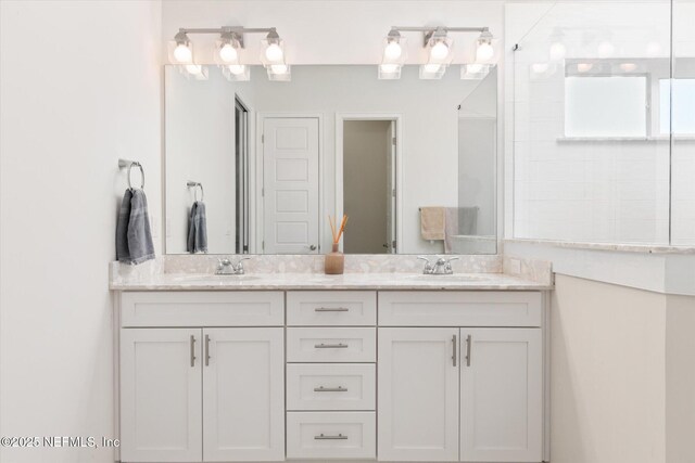 full bathroom featuring double vanity and a sink