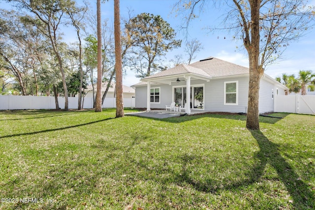 back of house featuring a patio area, a fenced backyard, a ceiling fan, and a yard