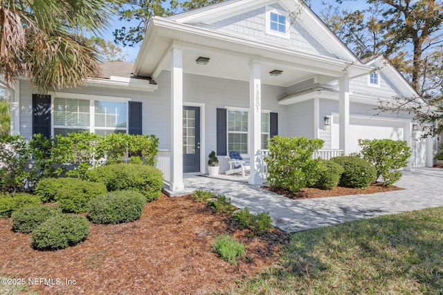 view of front of home with a garage and a porch