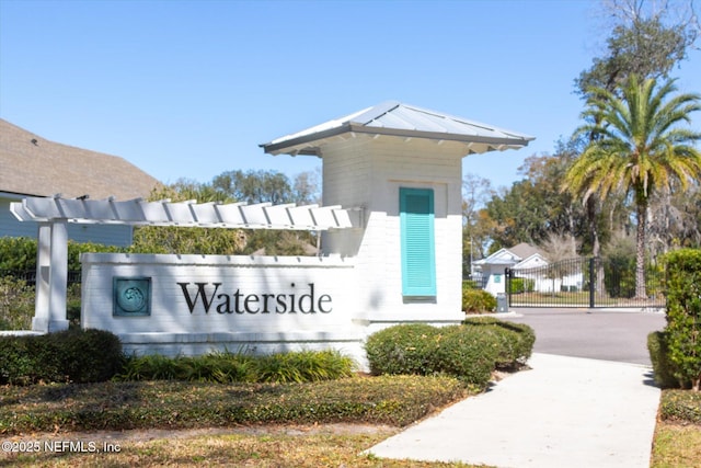 community sign featuring a gate